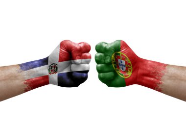Two hands punch to each others on white background. Country flags painted fists, conflict crisis concept between dominican republic and portugal