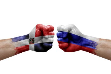 Two hands punch to each others on white background. Country flags painted fists, conflict crisis concept between dominican republic and russia