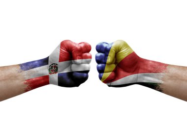 Two hands punch to each others on white background. Country flags painted fists, conflict crisis concept between dominican republic and seychelles