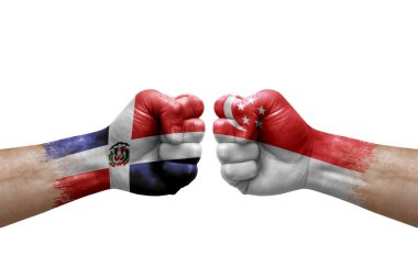 Two hands punch to each others on white background. Country flags painted fists, conflict crisis concept between dominican republic and singapore