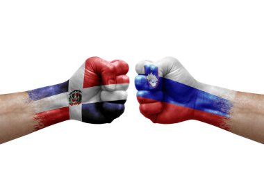 Two hands punch to each others on white background. Country flags painted fists, conflict crisis concept between dominican republic and slovenia