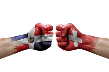 Two hands punch to each others on white background. Country flags painted fists, conflict crisis concept between dominican republic and switzerland