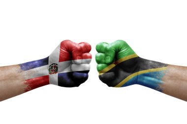 Two hands punch to each others on white background. Country flags painted fists, conflict crisis concept between dominican republic and tanzania