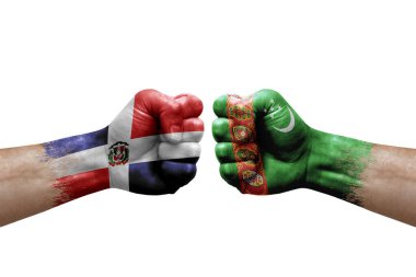 Two hands punch to each others on white background. Country flags painted fists, conflict crisis concept between dominican republic and turkmenistan