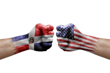Two hands punch to each others on white background. Country flags painted fists, conflict crisis concept between dominican republic and usa