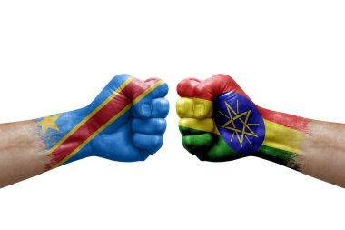 Two hands punch to each others on white background. Country flags painted fists, conflict crisis concept between dr congo and ethiopia