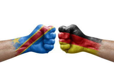 Two hands punch to each others on white background. Country flags painted fists, conflict crisis concept between dr congo and germany