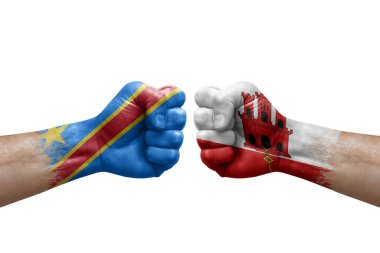 Two hands punch to each others on white background. Country flags painted fists, conflict crisis concept between dr congo and gibraltar