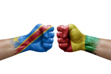 Two hands punch to each others on white background. Country flags painted fists, conflict crisis concept between dr congo and guinea
