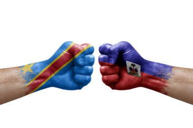Two hands punch to each others on white background. Country flags painted fists, conflict crisis concept between dr congo and haiti