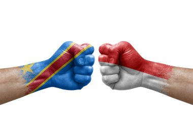 Two hands punch to each others on white background. Country flags painted fists, conflict crisis concept between dr congo and indonesia