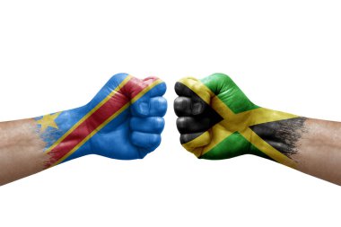 Two hands punch to each others on white background. Country flags painted fists, conflict crisis concept between dr congo and jamaica
