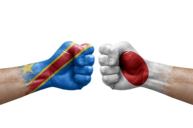 Two hands punch to each others on white background. Country flags painted fists, conflict crisis concept between dr congo and japan