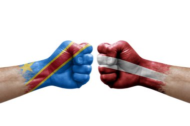 Two hands punch to each others on white background. Country flags painted fists, conflict crisis concept between dr congo and latvia