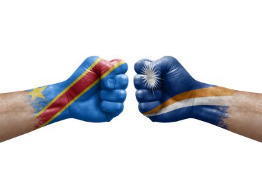 Two hands punch to each others on white background. Country flags painted fists, conflict crisis concept between dr congo and marshall islands