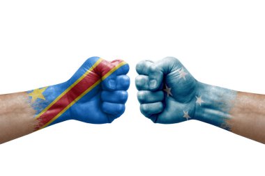 Two hands punch to each others on white background. Country flags painted fists, conflict crisis concept between dr congo and micronesia