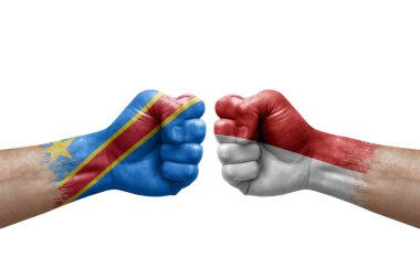 Two hands punch to each others on white background. Country flags painted fists, conflict crisis concept between dr congo and monaco