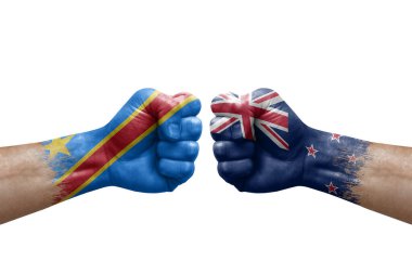 Two hands punch to each others on white background. Country flags painted fists, conflict crisis concept between dr congo and new zealand
