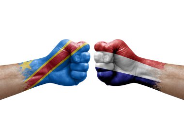Two hands punch to each others on white background. Country flags painted fists, conflict crisis concept between dr congo and netherlands