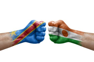 Two hands punch to each others on white background. Country flags painted fists, conflict crisis concept between dr congo and niger