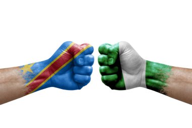 Two hands punch to each others on white background. Country flags painted fists, conflict crisis concept between dr congo and nigeria