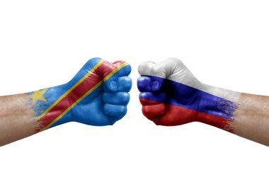 Two hands punch to each others on white background. Country flags painted fists, conflict crisis concept between dr congo and russia