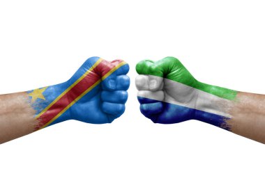 Two hands punch to each others on white background. Country flags painted fists, conflict crisis concept between dr congo and sierra leone