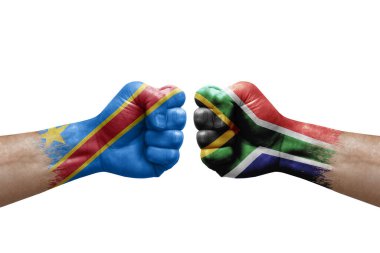 Two hands punch to each others on white background. Country flags painted fists, conflict crisis concept between dr congo and south africa