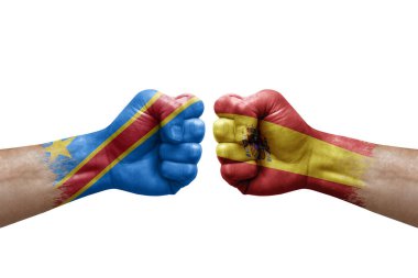 Two hands punch to each others on white background. Country flags painted fists, conflict crisis concept between dr congo and spain
