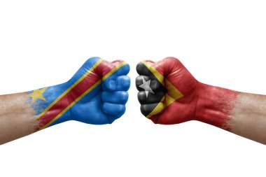 Two hands punch to each others on white background. Country flags painted fists, conflict crisis concept between dr congo and timor leste