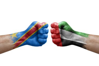 Two hands punch to each others on white background. Country flags painted fists, conflict crisis concept between dr congo and united arab emirates
