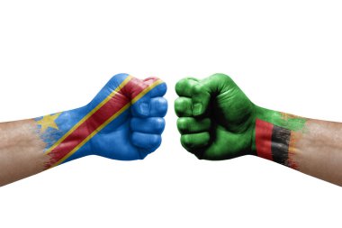Two hands punch to each others on white background. Country flags painted fists, conflict crisis concept between dr congo and zambia