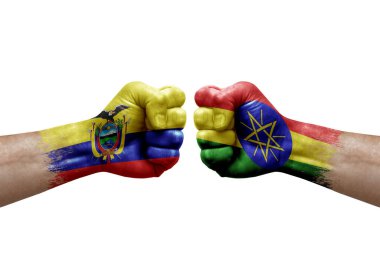 Two hands punch to each others on white background. Country flags painted fists, conflict crisis concept between ecuador and ethiopia