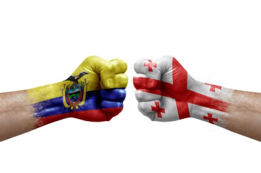 Two hands punch to each others on white background. Country flags painted fists, conflict crisis concept between ecuador and georgia