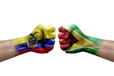 Two hands punch to each others on white background. Country flags painted fists, conflict crisis concept between ecuador and guyana