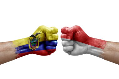 Two hands punch to each others on white background. Country flags painted fists, conflict crisis concept between ecuador and indonesia
