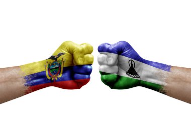 Two hands punch to each others on white background. Country flags painted fists, conflict crisis concept between ecuador and lesotho