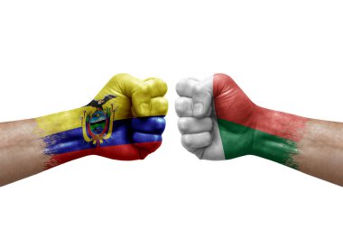 Two hands punch to each others on white background. Country flags painted fists, conflict crisis concept between ecuador and madagascar