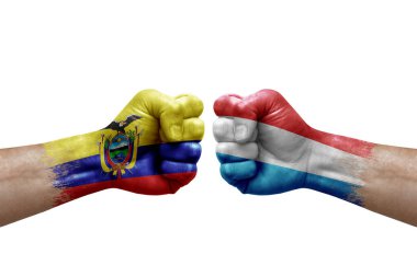 Two hands punch to each others on white background. Country flags painted fists, conflict crisis concept between ecuador and luxembourg