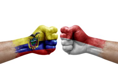 Two hands punch to each others on white background. Country flags painted fists, conflict crisis concept between ecuador and monaco