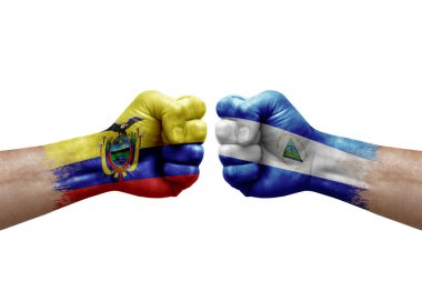 Two hands punch to each others on white background. Country flags painted fists, conflict crisis concept between ecuador and nicaragua
