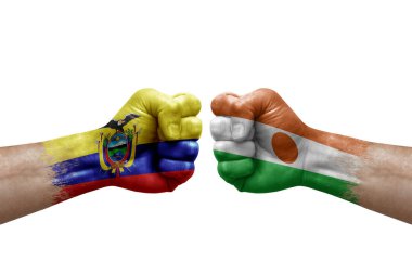 Two hands punch to each others on white background. Country flags painted fists, conflict crisis concept between ecuador and niger