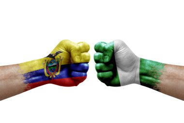 Two hands punch to each others on white background. Country flags painted fists, conflict crisis concept between ecuador and nigeria