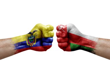 Two hands punch to each others on white background. Country flags painted fists, conflict crisis concept between ecuador and oman