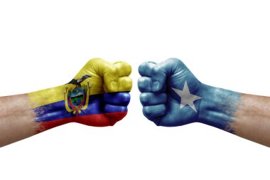 Two hands punch to each others on white background. Country flags painted fists, conflict crisis concept between ecuador and somalia