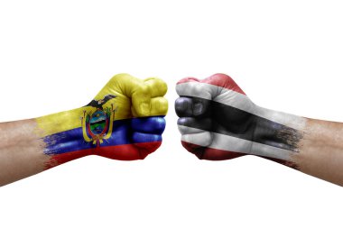 Two hands punch to each others on white background. Country flags painted fists, conflict crisis concept between ecuador and thailand