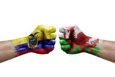 Two hands punch to each others on white background. Country flags painted fists, conflict crisis concept between ecuador and wales