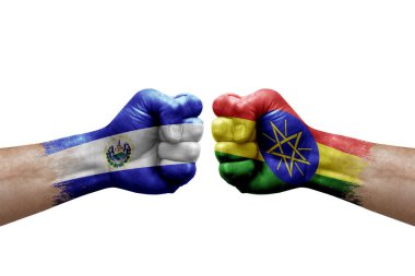 Two hands punch to each others on white background. Country flags painted fists, conflict crisis concept between el salvador and ethiopia