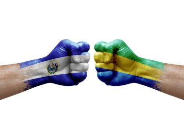 Two hands punch to each others on white background. Country flags painted fists, conflict crisis concept between el salvador and gabon