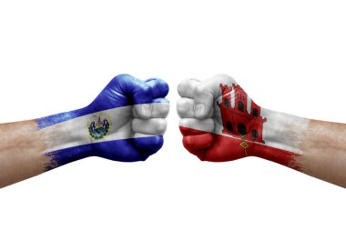 Two hands punch to each others on white background. Country flags painted fists, conflict crisis concept between el salvador and gibraltar